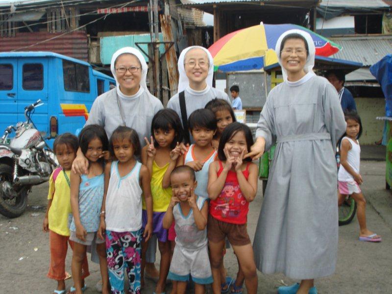 with linchangco feeding children in the village